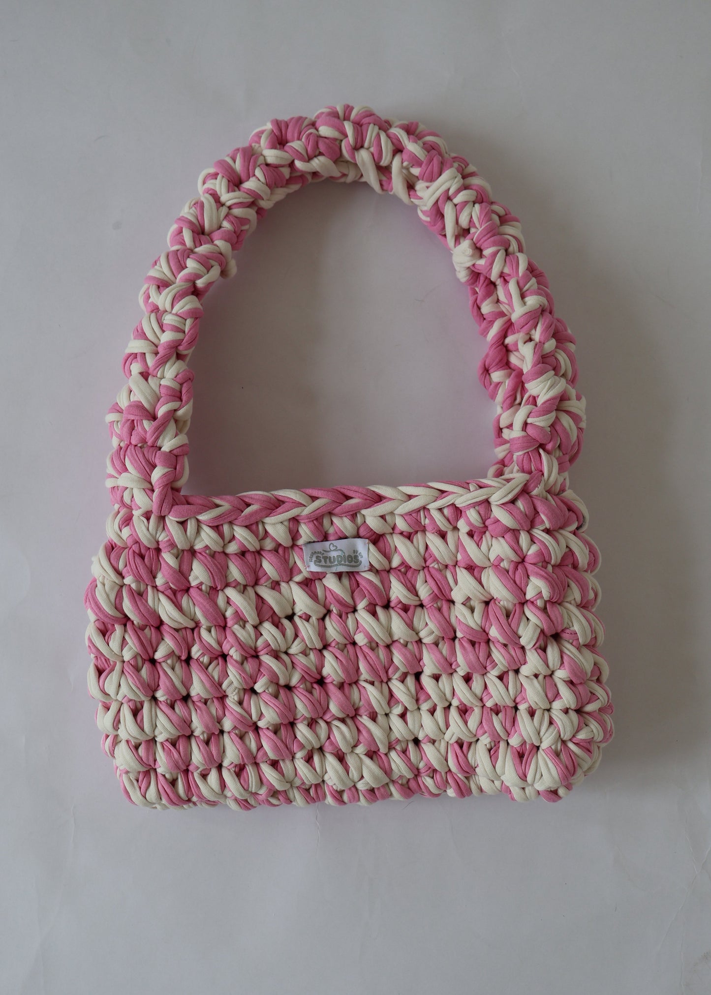 Handmade crochet shoulder bag in pink and white yarn