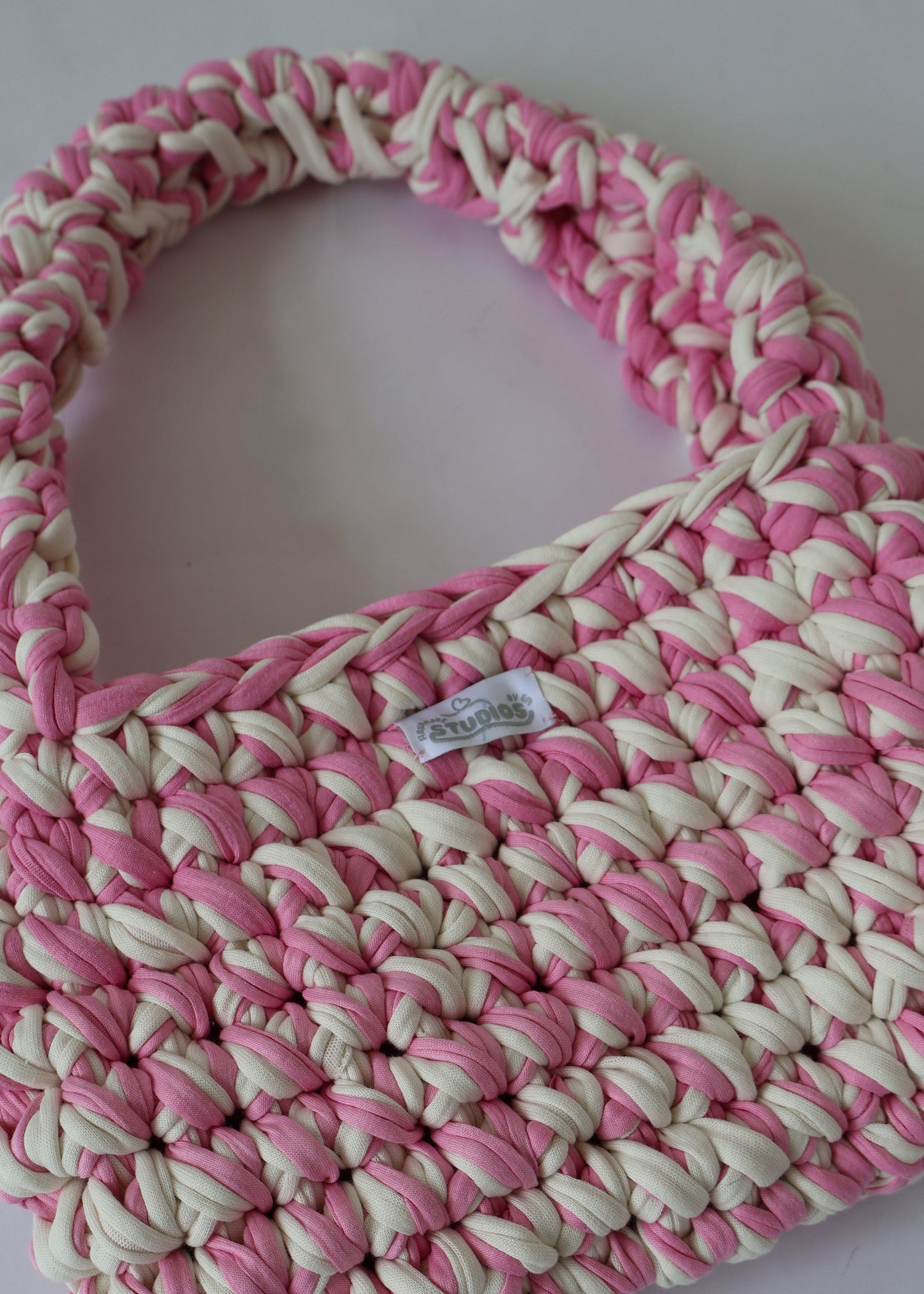 Handmade crochet shoulder bag in pink and white yarn