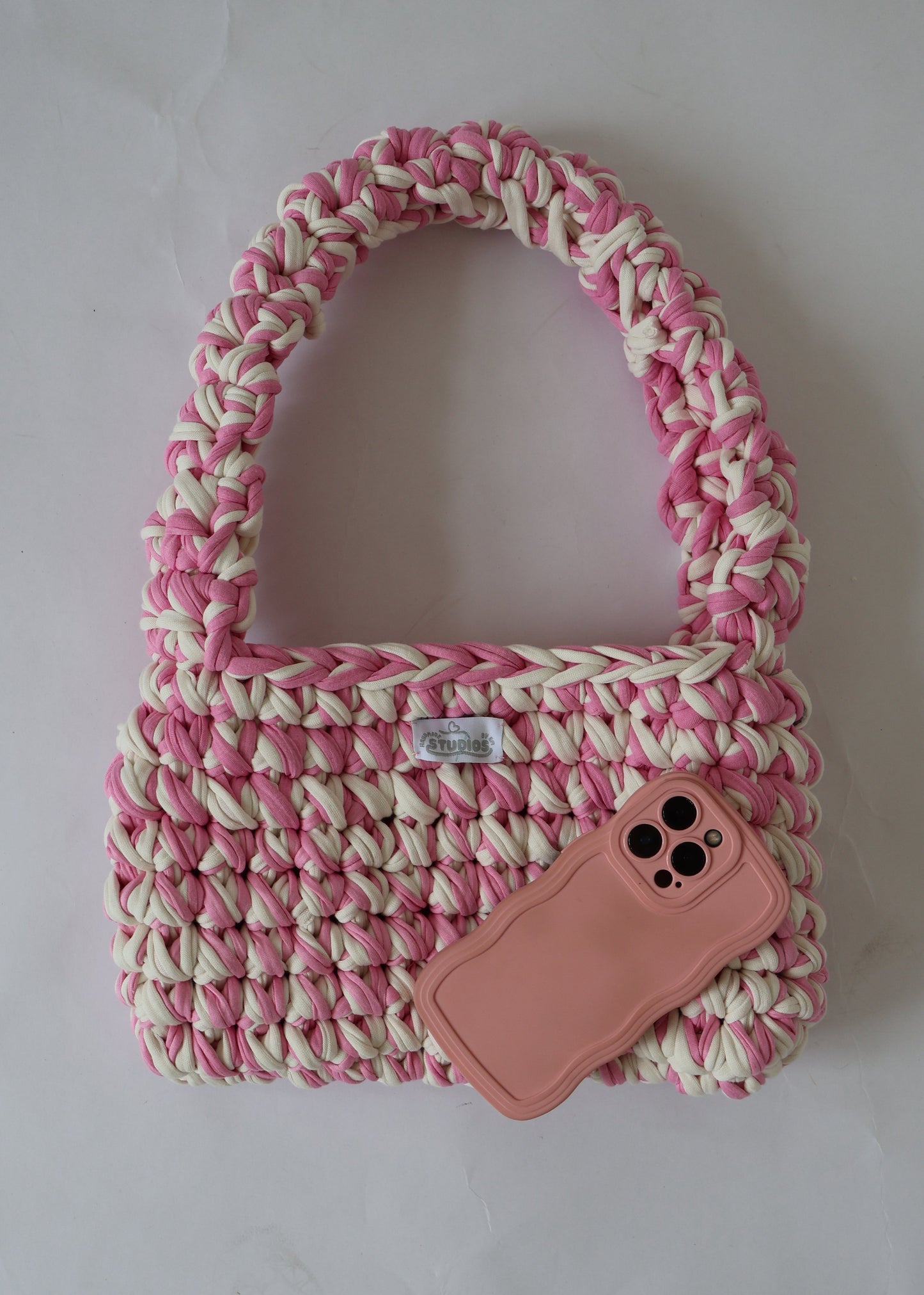 Handmade crochet shoulder bag in pink and white yarn