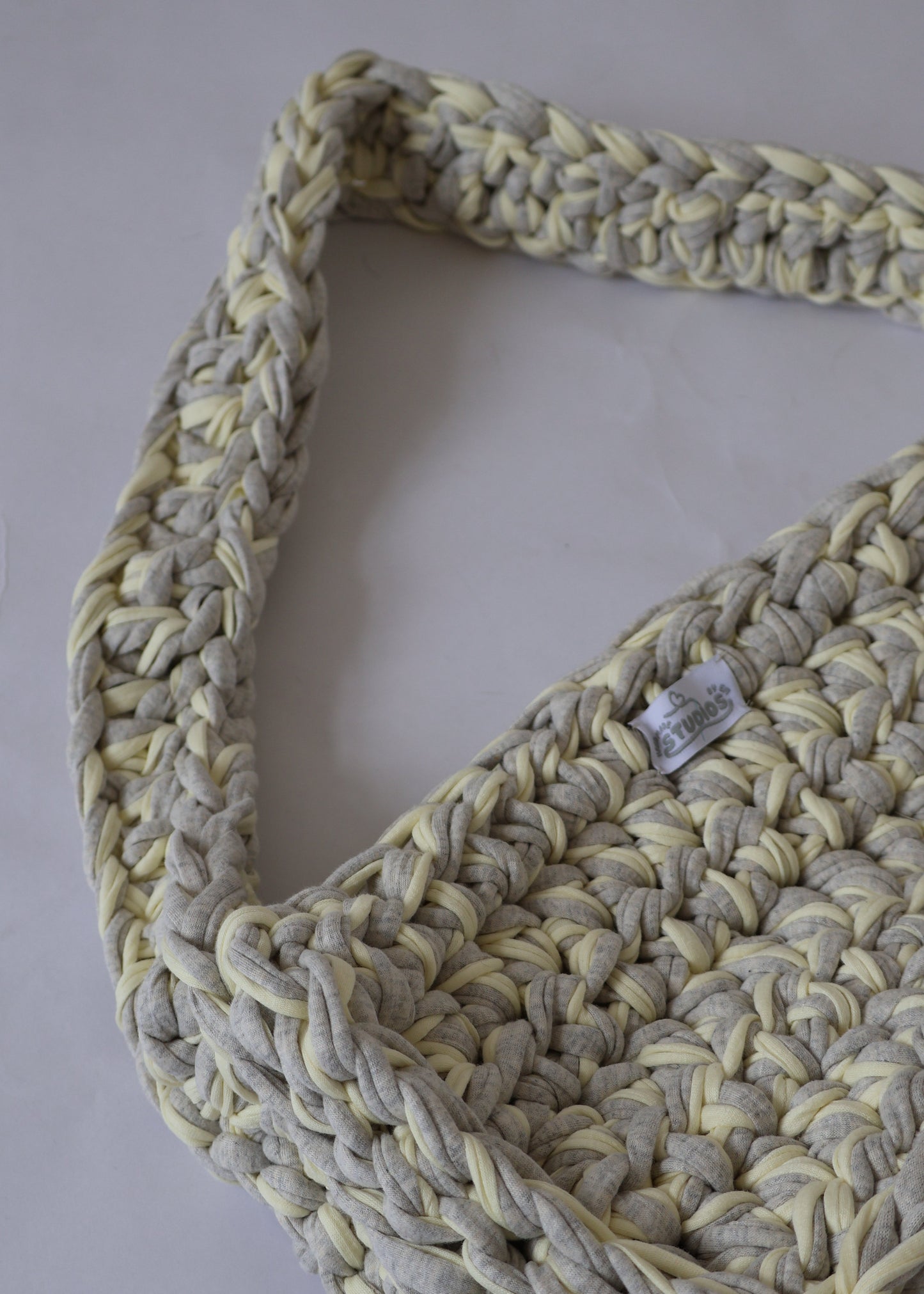 Soft, slouchy, and sustainably made—this lemon and grey crochet shoulder bag is perfect for relaxed, everyday outfits.