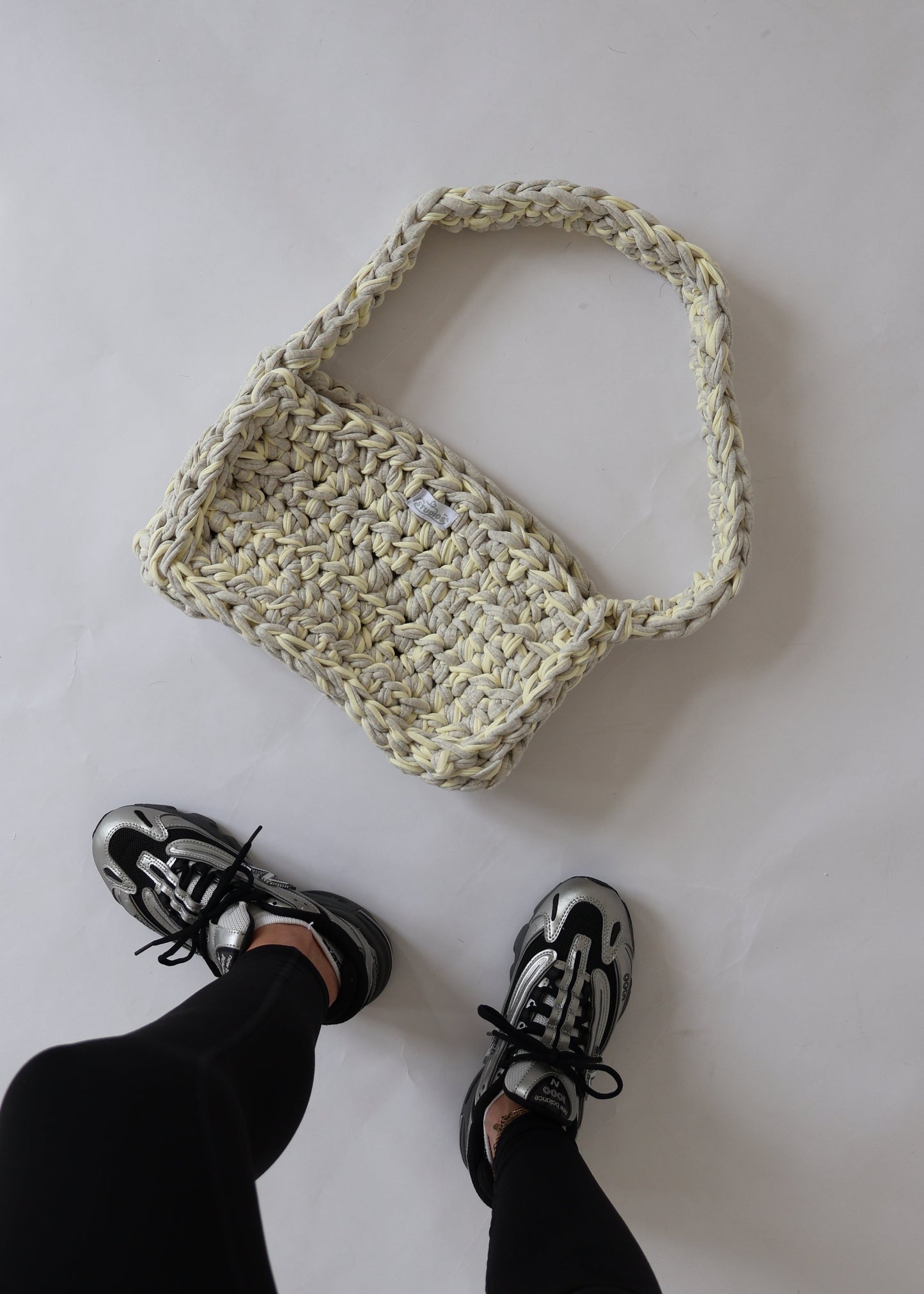 Soft, slouchy, and sustainably made—this lemon and grey crochet shoulder bag is perfect for relaxed, everyday outfits.