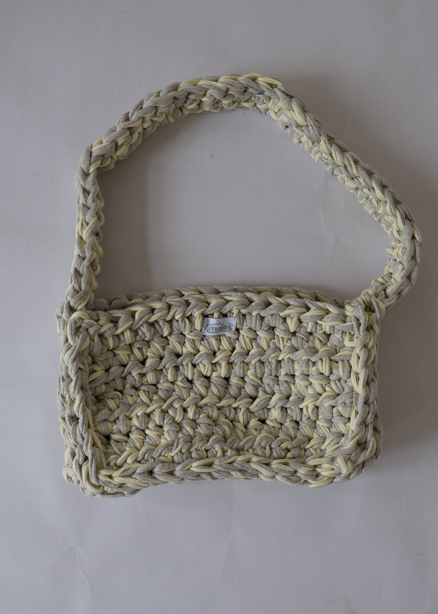 Soft, slouchy, and sustainably made—this lemon and grey crochet shoulder bag is perfect for relaxed, everyday outfits.