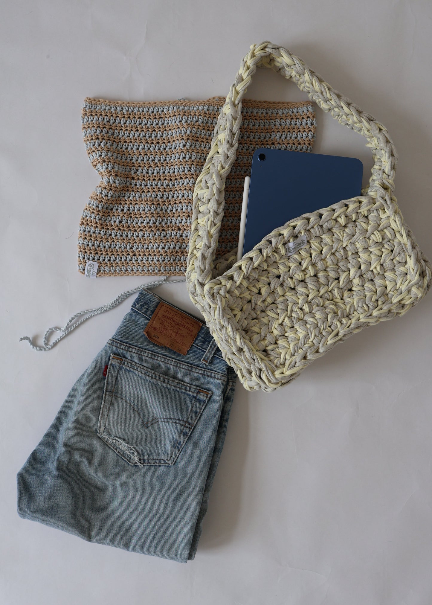 Soft, slouchy, and sustainably made—this lemon and grey crochet shoulder bag is perfect for relaxed, everyday outfits.