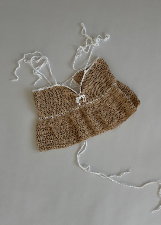 Handmade crochet babydoll top with ruffle details and a cropped fit. Lightweight, flirty, and perfect for summer layering.